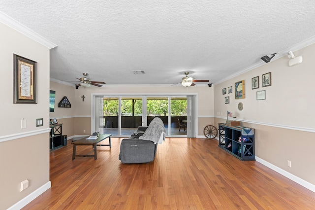 11447 Orange Grove Blvd, West Palm Beach, FL 33411 - living room with a ceiling fan, light wood-style floors, a textured ceiling, crown molding, and baseboards