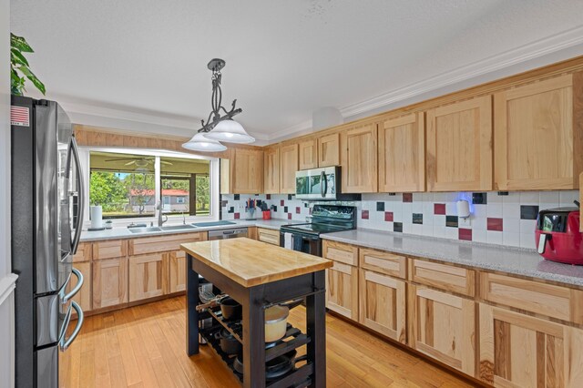 11447 Orange Grove Blvd, West Palm Beach, FL 33411 - kitchen with appliances with stainless steel finishes, a sink, light brown cabinets, backsplash, and butcher block countertops