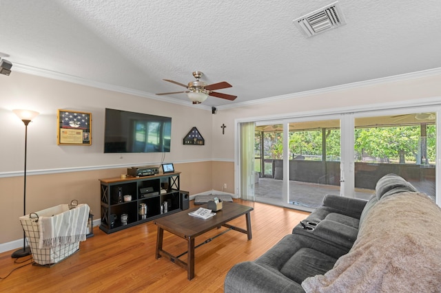 11447 Orange Grove Blvd, West Palm Beach, FL 33411 - living room with crown molding, ceiling fan, a textured ceiling, wood finished floors, and healthy amount of natural light