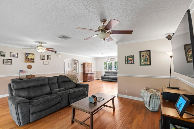 11447 Orange Grove Blvd, West Palm Beach, FL 33411 - living area with a ceiling fan, arched walkways, crown molding, wood finished floors, and a textured ceiling