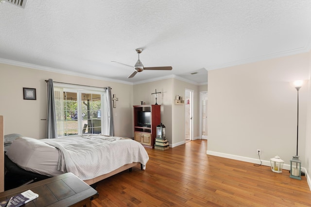 11447 Orange Grove Blvd, West Palm Beach, FL 33411 - bedroom with crown molding, wood finished floors, baseboards, a textured ceiling, and ceiling fan