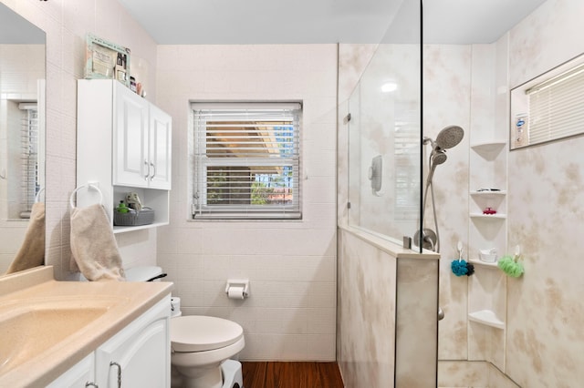11447 Orange Grove Blvd, West Palm Beach, FL 33411 - full bathroom featuring walk in shower, vanity, toilet, wood finished floors, and tile walls