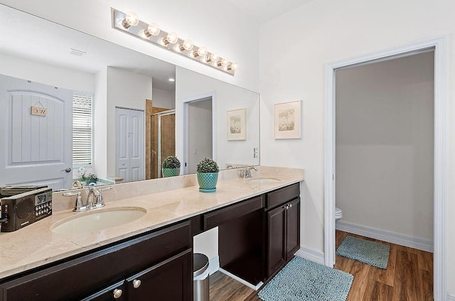 7267 Prudencia Dr, Lake Worth, FL 33463 - bathroom featuring toilet, a shower stall, double vanity, and wood finished floors