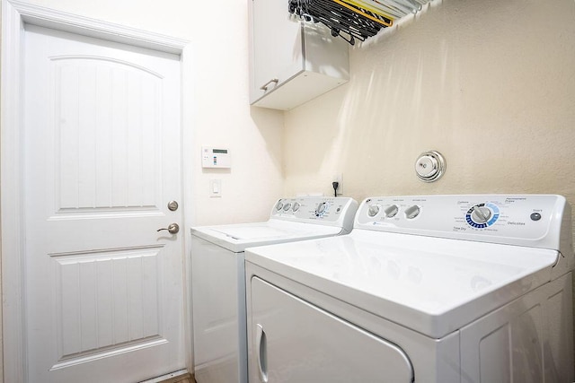 7267 Prudencia Dr, Lake Worth, FL 33463 - clothes washing area with cabinet space and separate washer and dryer
