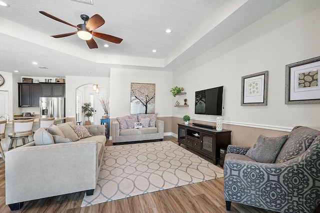 7267 Prudencia Dr, Lake Worth, FL 33463 - living room featuring wood finished floors, ceiling fan, recessed lighting, a raised ceiling, and arched walkways