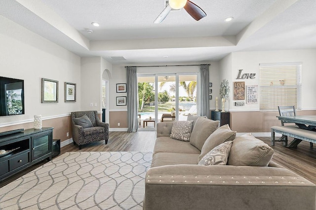 7267 Prudencia Dr, Lake Worth, FL 33463 - living area with wood finished floors, arched walkways, baseboards, a raised ceiling, and ceiling fan