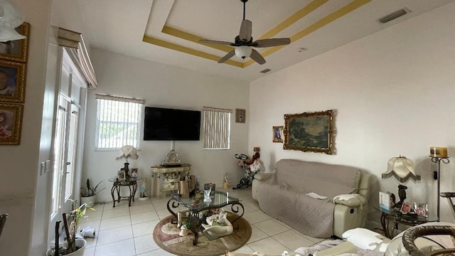 2332 SW Savona Blvd, Port Saint Lucie, FL 34953 - living room featuring ceiling fan, light tile patterned flooring, and a tray ceiling