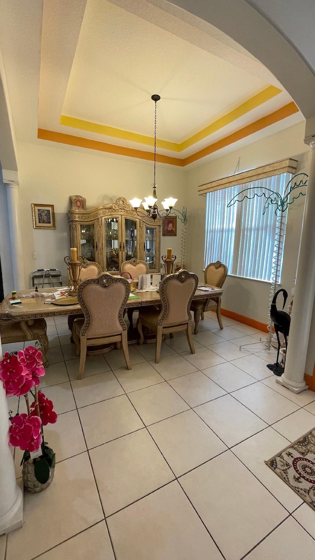 2332 SW Savona Blvd, Port Saint Lucie, FL 34953 - dining space with a raised ceiling, arched walkways, decorative columns, and light tile patterned floors