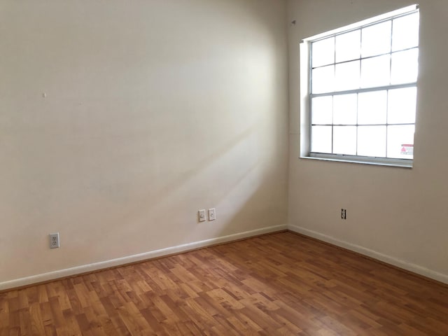 720 Cypress Ln Unit K, Deerfield Beach, FL 33064 - spare room featuring wood finished floors and baseboards