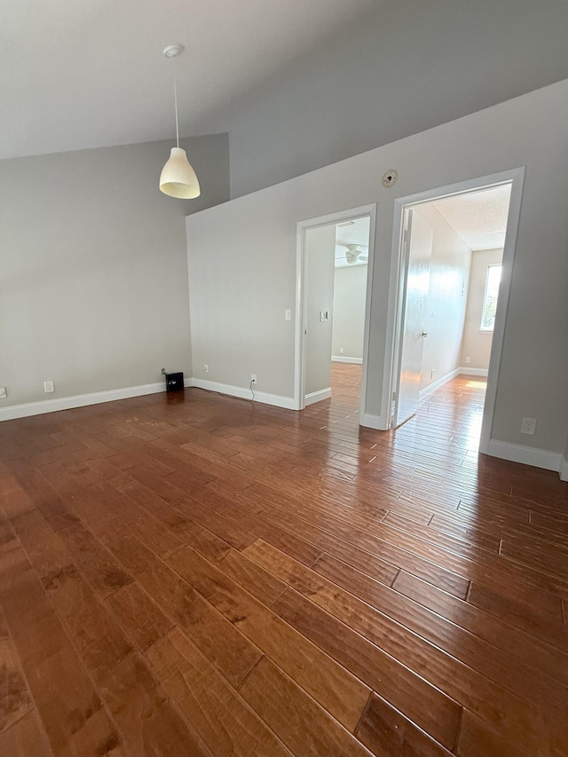 310 SE 2nd Ave Unit A3, Deerfield Beach, FL 33441 - spare room featuring dark wood-type flooring, baseboards, and vaulted ceiling