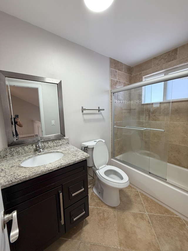 310 SE 2nd Ave Unit A3, Deerfield Beach, FL 33441 - bathroom featuring shower / bath combination with glass door, toilet, vanity, and tile patterned flooring