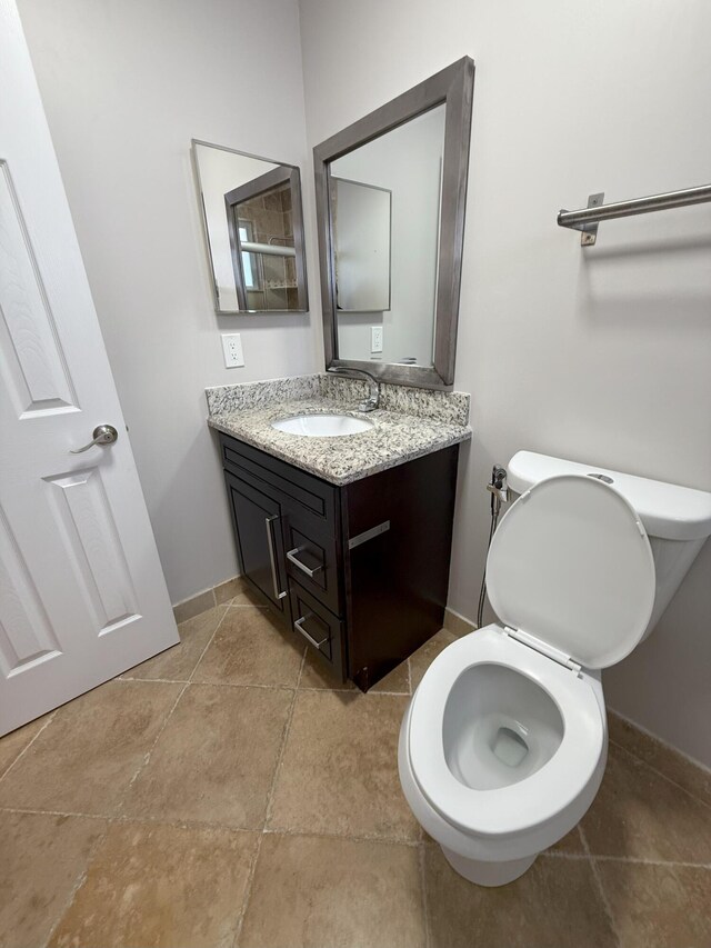 310 SE 2nd Ave Unit A3, Deerfield Beach, FL 33441 - bathroom with toilet, vanity, and baseboards