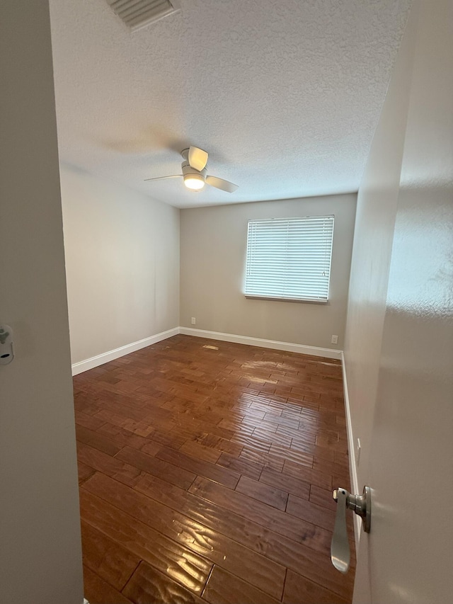 310 SE 2nd Ave Unit A3, Deerfield Beach, FL 33441 - empty room featuring wood-type flooring, a textured ceiling, a ceiling fan, and baseboards
