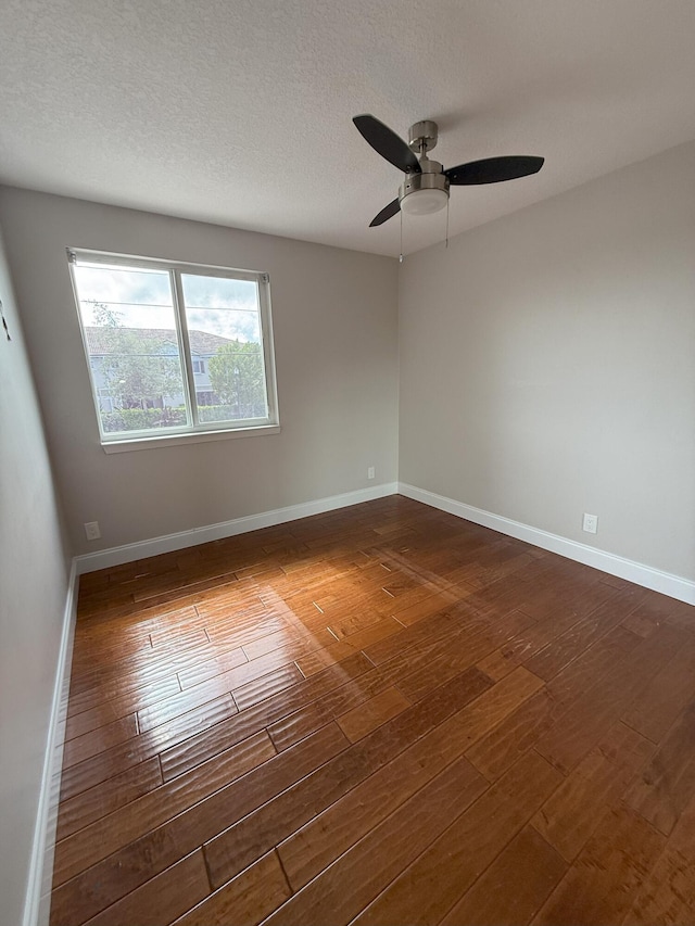310 SE 2nd Ave Unit A3, Deerfield Beach, FL 33441 - unfurnished room featuring dark wood-type flooring, a ceiling fan, baseboards, and a textured ceiling