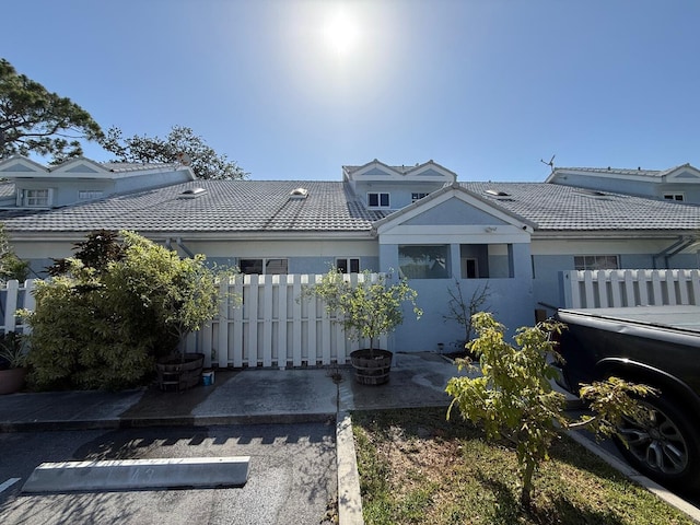 310 SE 2nd Ave Unit A3, Deerfield Beach, FL 33441 - view of front of home with a tile roof, fence, stucco siding, and a patio