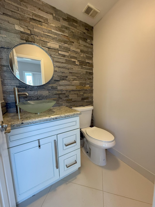 310 SE 2nd Ave Unit A3, Deerfield Beach, FL 33441 - bathroom with tile patterned flooring, toilet, vanity, and backsplash