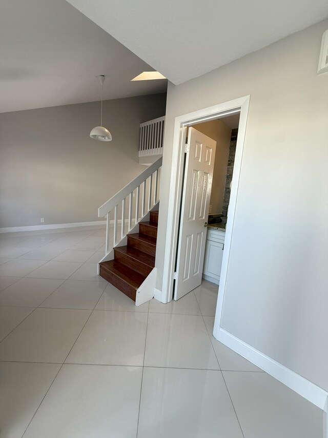 310 SE 2nd Ave Unit A3, Deerfield Beach, FL 33441 - stairs with tile patterned flooring, baseboards, and lofted ceiling