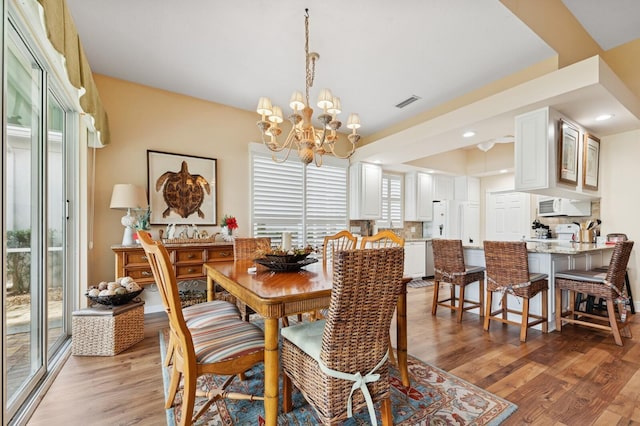 2596 Irma Lake Dr, West Palm Beach, FL 33411 - dining room featuring plenty of natural light, light wood-style floors, a chandelier, and recessed lighting
