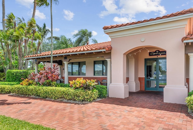 2596 Irma Lake Dr, West Palm Beach, FL 33411 - entrance to property featuring a tiled roof, french doors, and stucco siding