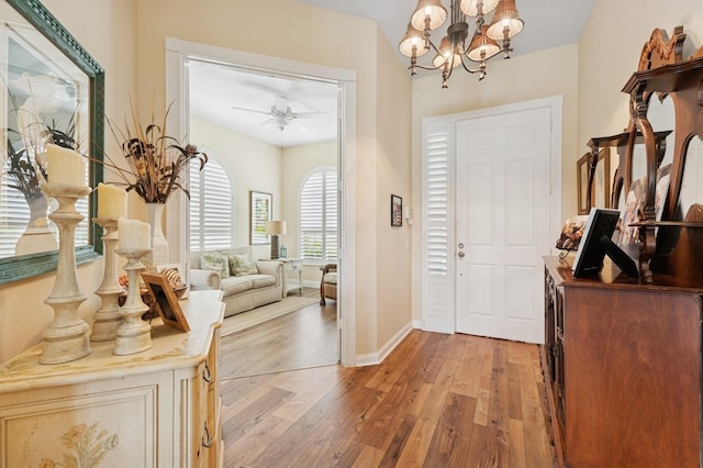 2596 Irma Lake Dr, West Palm Beach, FL 33411 - foyer entrance featuring light wood-style floors, a chandelier, ceiling fan, and baseboards