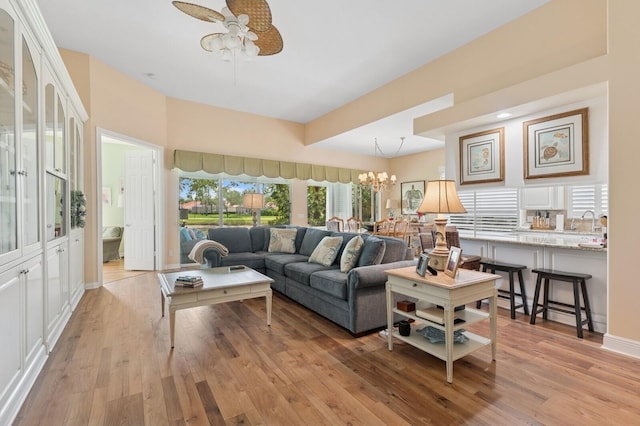 2596 Irma Lake Dr, West Palm Beach, FL 33411 - living room featuring a ceiling fan, light wood finished floors, and a chandelier