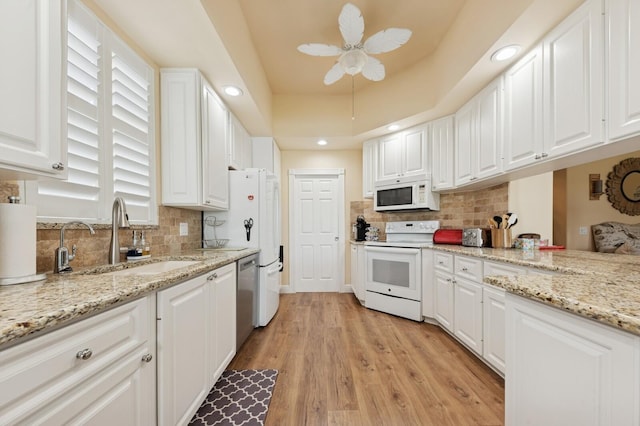 2596 Irma Lake Dr, West Palm Beach, FL 33411 - kitchen featuring white appliances, a sink, tasteful backsplash, white cabinetry, and recessed lighting