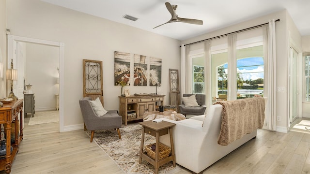 6193 Winding Lake Dr, Jupiter, FL 33458 - living area featuring light wood-type flooring, a ceiling fan, and baseboards