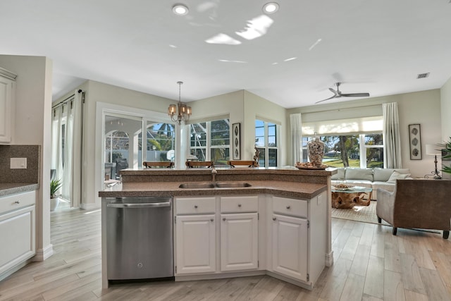 6193 Winding Lake Dr, Jupiter, FL 33458 - kitchen featuring stainless steel dishwasher, a sink, open floor plan, plenty of natural light, and recessed lighting