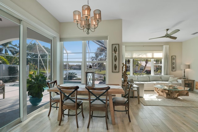 6193 Winding Lake Dr, Jupiter, FL 33458 - dining space with light wood-style flooring, plenty of natural light, a ceiling fan, and a chandelier