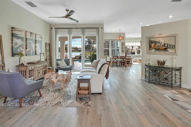6193 Winding Lake Dr, Jupiter, FL 33458 - living room featuring a ceiling fan, plenty of natural light, wood finished floors, recessed lighting, and a chandelier