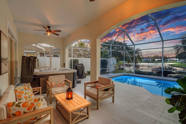 6193 Winding Lake Dr, Jupiter, FL 33458 - pool at dusk featuring an outdoor pool, a patio, a hot tub, and glass enclosure