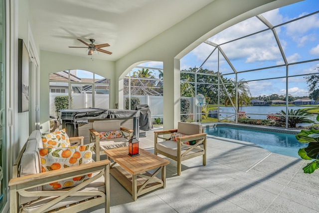 6193 Winding Lake Dr, Jupiter, FL 33458 - sunroom featuring a hot tub, a ceiling fan, a swimming pool, and a water view