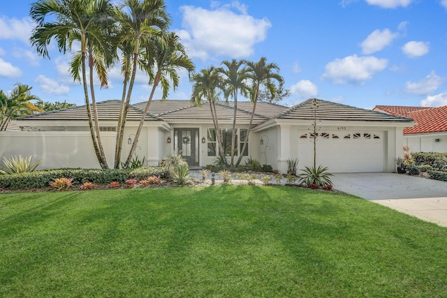 6193 Winding Lake Dr, Jupiter, FL 33458 - ranch-style home featuring an attached garage, a front lawn, stucco siding, driveway, and a tiled roof