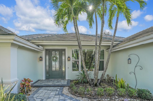 6193 Winding Lake Dr, Jupiter, FL 33458 - property entrance with stucco siding and a tiled roof