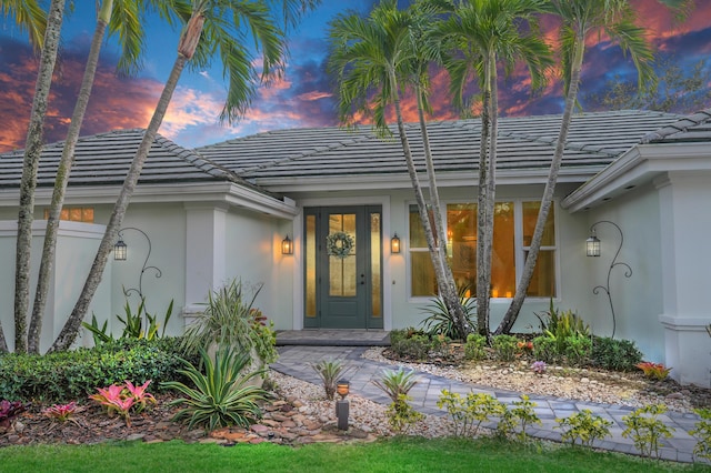 6193 Winding Lake Dr, Jupiter, FL 33458 - view of exterior entry with stucco siding and a tile roof