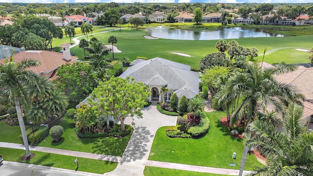 aerial perspective of suburban area featuring a nearby body of water and a golf course