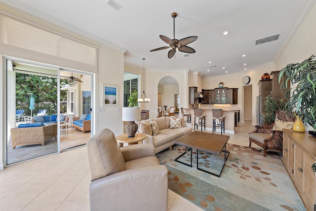 living room featuring a ceiling fan, light tile patterned floors, arched walkways, crown molding, and recessed lighting
