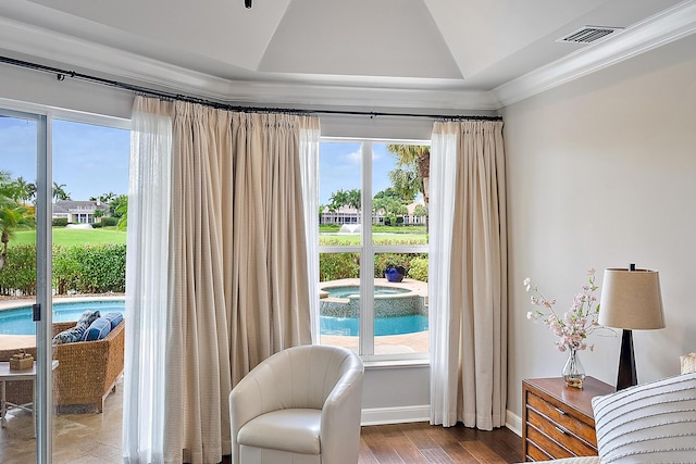 sitting room featuring vaulted ceiling, plenty of natural light, baseboards, crown molding, and wood finished floors