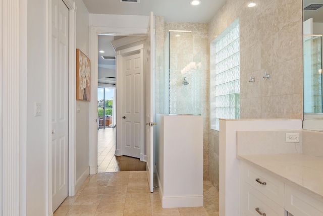 bathroom with a walk in shower, tile patterned flooring, tile walls, and recessed lighting