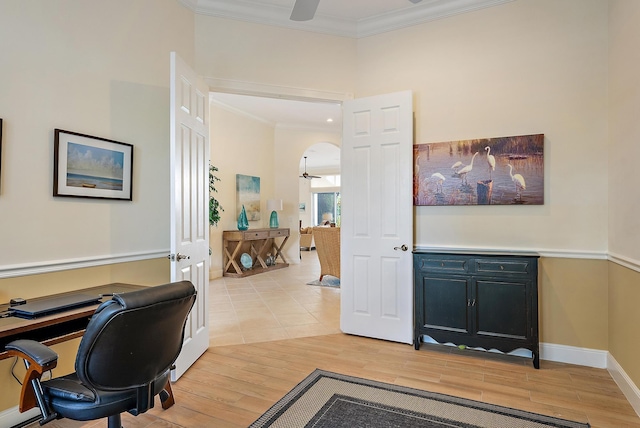 home office featuring a ceiling fan, crown molding, light wood-type flooring, and baseboards