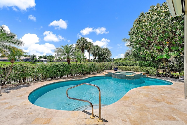 view of pool with a patio area and a pool with connected hot tub