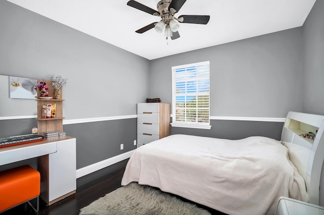 bedroom featuring wood finished floors, baseboards, and a ceiling fan