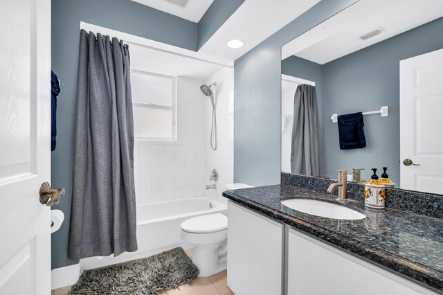 full bathroom featuring toilet, vanity, shower / bathtub combination with curtain, and tile patterned floors