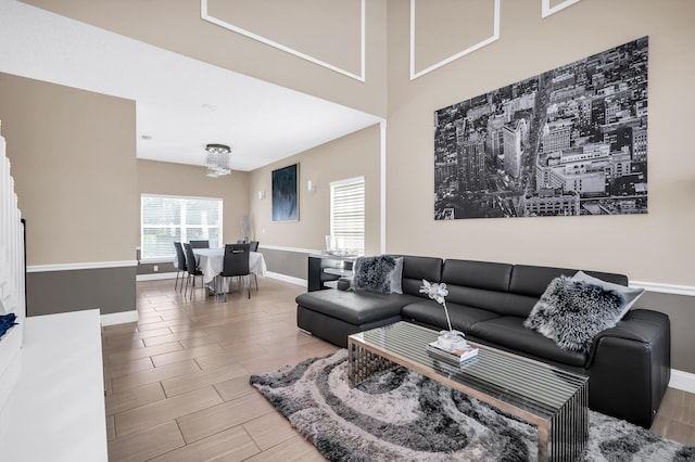 living room with baseboards and wood tiled floors