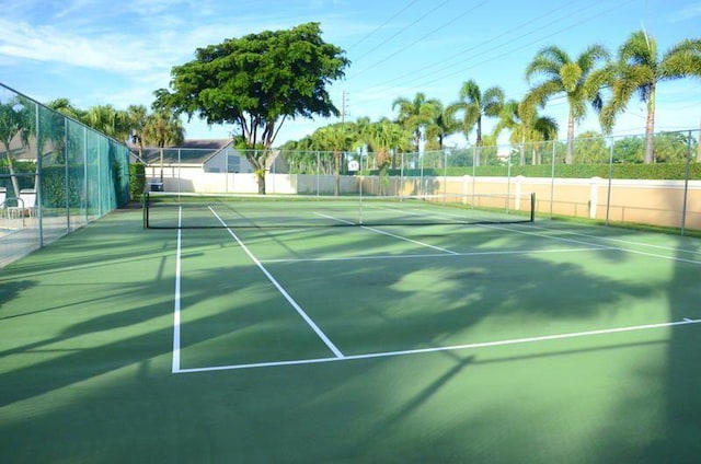 view of tennis court featuring fence