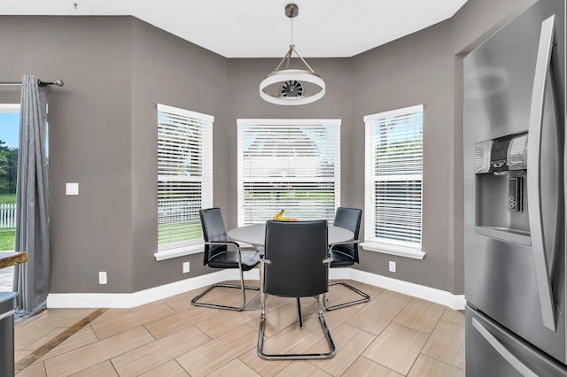dining space featuring baseboards and wood finish floors
