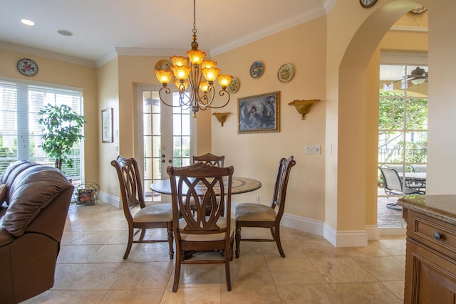 143 SE Bella Strano, Port Saint Lucie, FL 34984 - dining space featuring arched walkways, ornamental molding, a chandelier, baseboards, and french doors