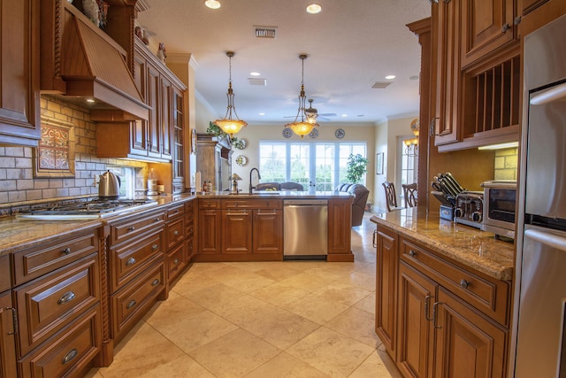143 SE Bella Strano, Port Saint Lucie, FL 34984 - kitchen with appliances with stainless steel finishes, custom range hood, a peninsula, tasteful backsplash, and brown cabinets