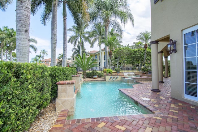 143 SE Bella Strano, Port Saint Lucie, FL 34984 - view of pool featuring fence, a patio area, and a pool with connected hot tub