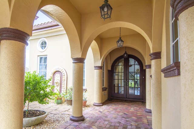 143 SE Bella Strano, Port Saint Lucie, FL 34984 - doorway to property with french doors and stucco siding